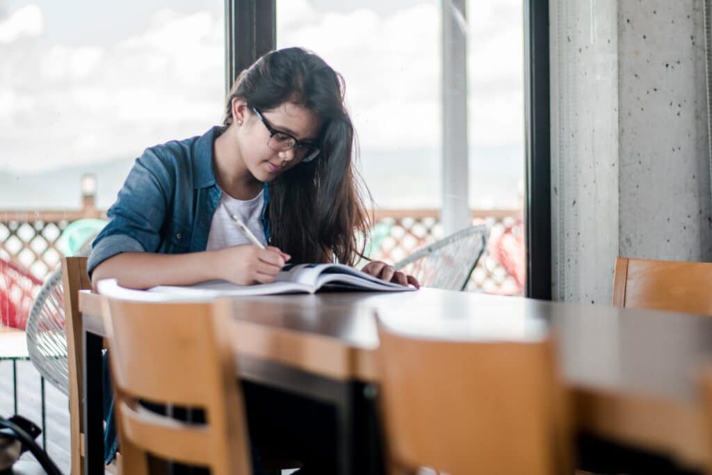 girl studying spanish at the dinner table