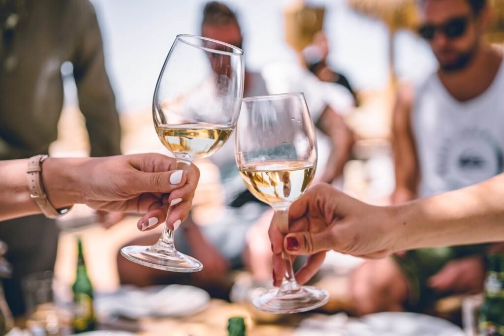 People cheersing two glasses of wine