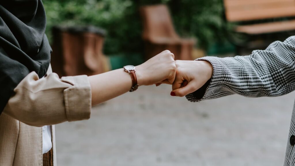 people fist bumping informally