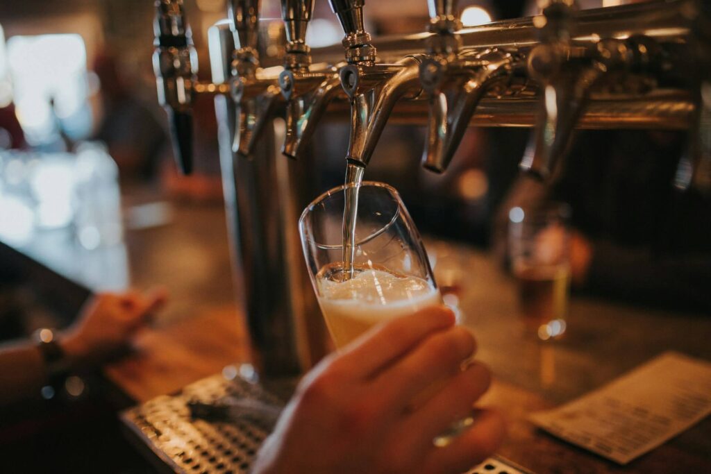 someone pouring a beer